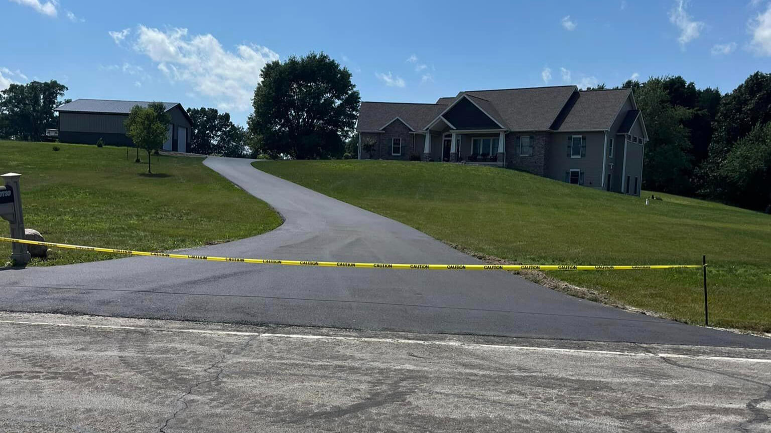 Long residential driveway with newly installed asphalt