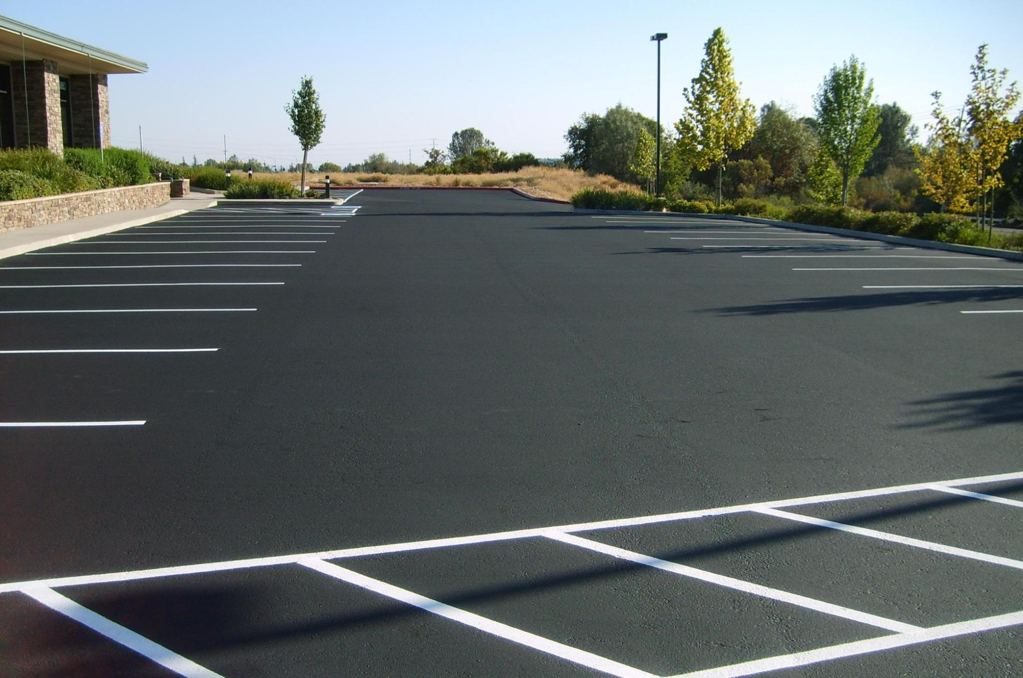 Finished asphalt parking lot with marked spaces
